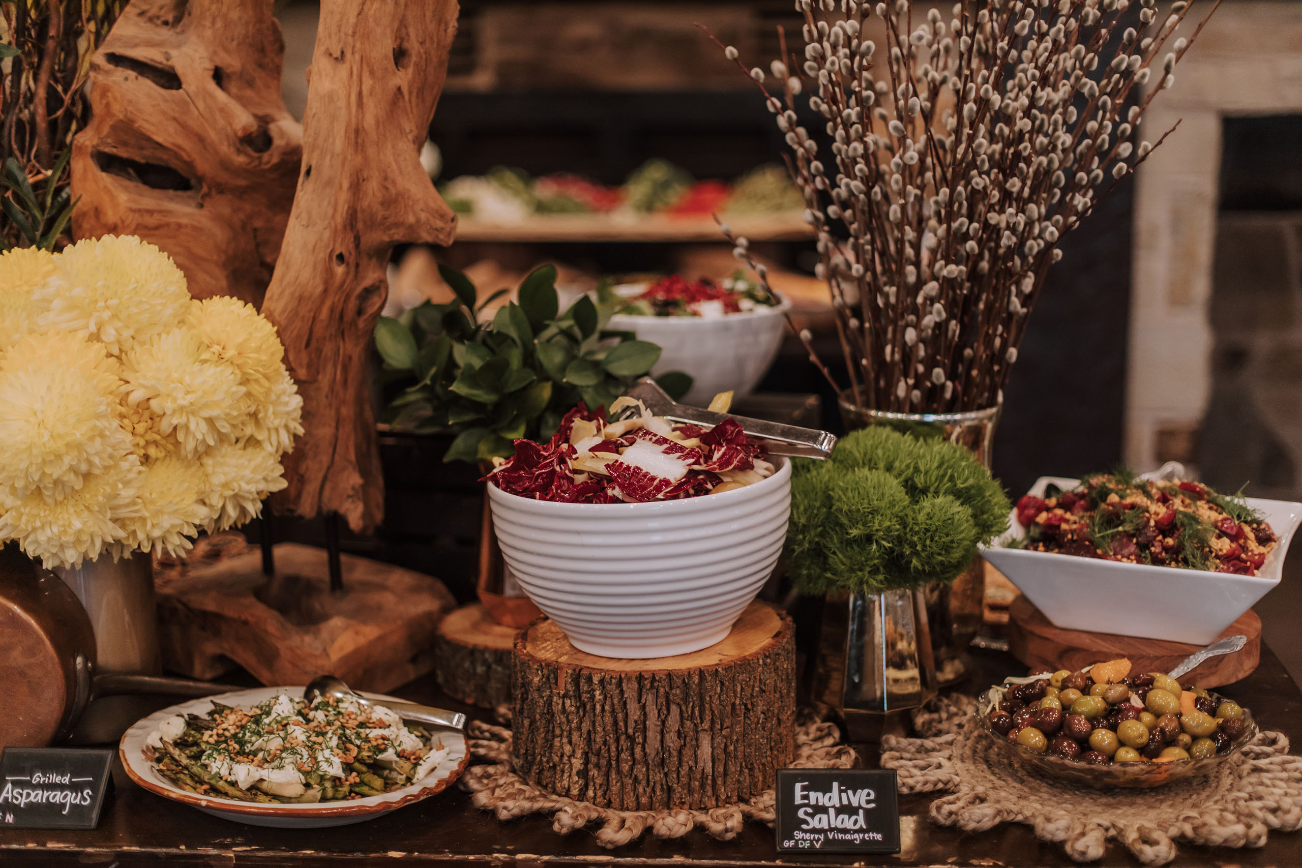 Buffet table with endive salad and grilled asparagus